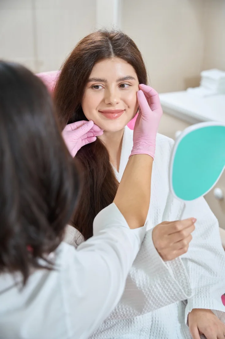 A woman receiving a facial treatment at a spa