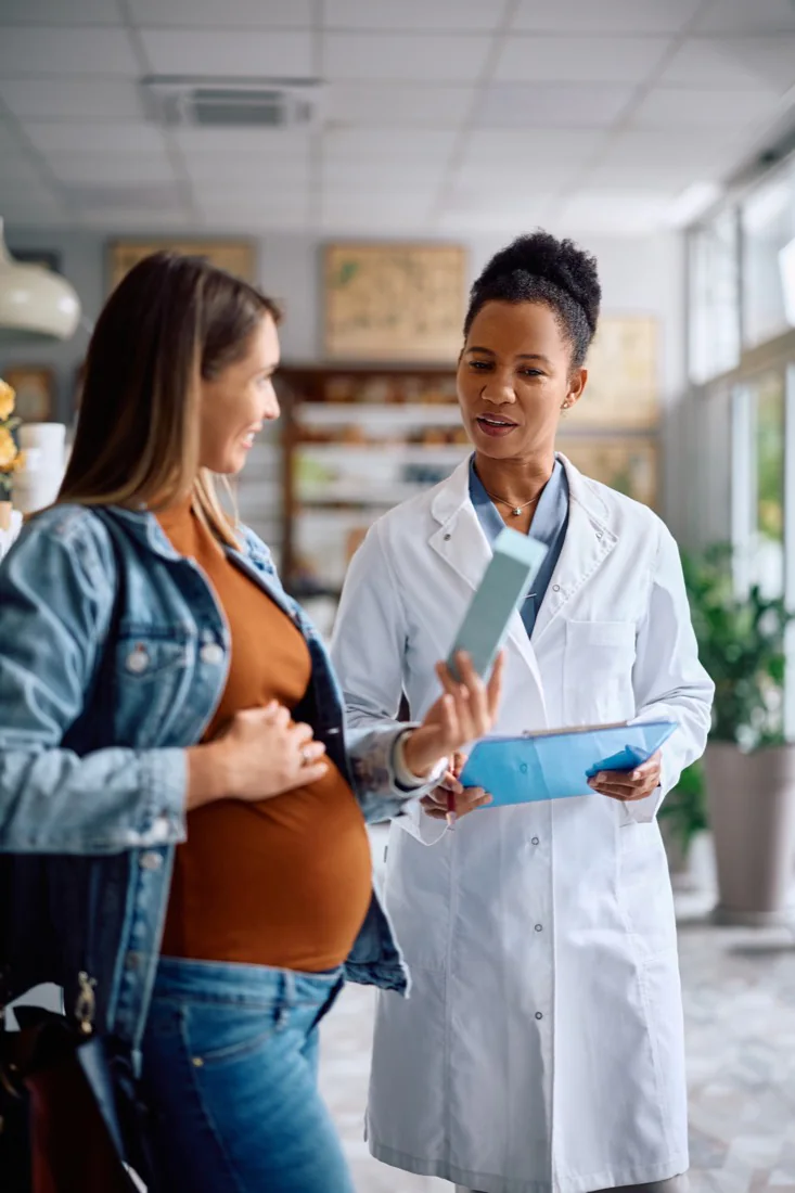 A pregnant woman consulting with her doctor in an office