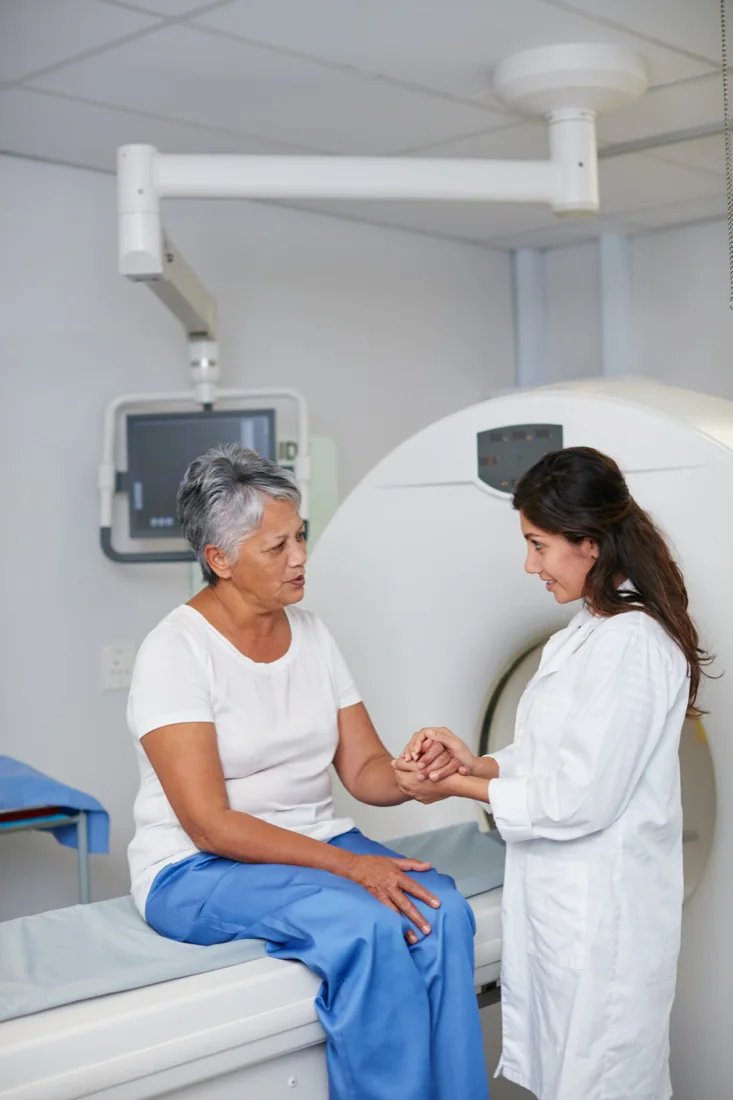 A doctor comforting a senior patient in hospital